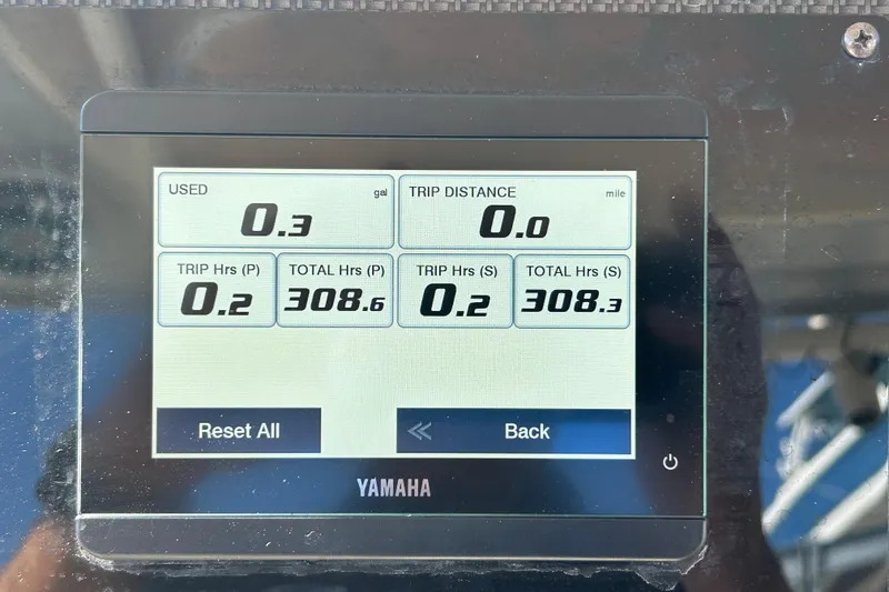 Slide: The Image of Yamaha display showing fuel usage and trip data on 2020 Grady-White Canyon 306 boat. - 26