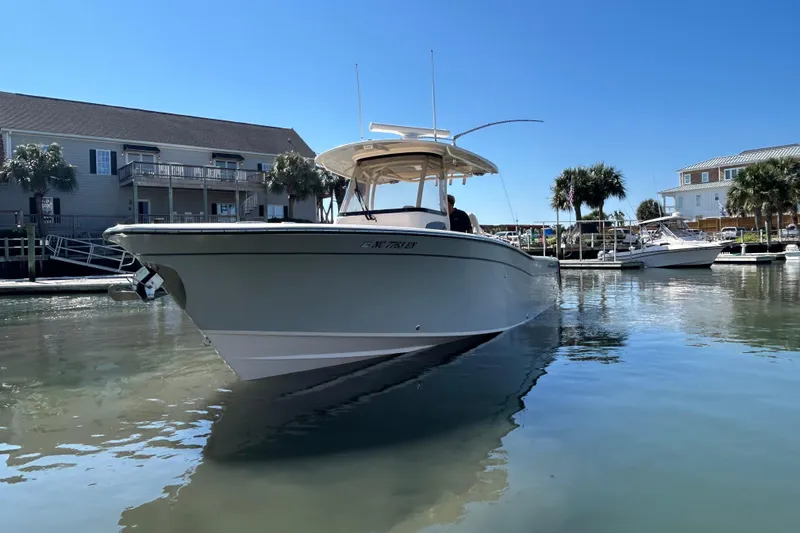 Slide: The Image of 2020 Grady-White Canyon 306 boat docked in a sunny marina setting. - 3
