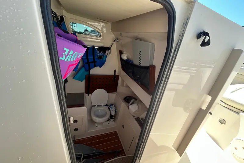 Slide: The Image of 2020 Grady-White Canyon 306 boat interior with toilet and storage area. - 30