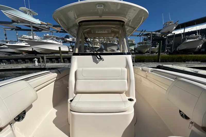 Slide: The Image of 2020 Grady-White Canyon 306 boat interior with seating, docked among other boats. - 33