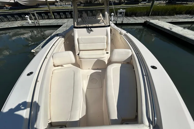 Slide: The Image of 2020 Grady-White Canyon 306 boat interior with cushioned seating at dock. - 34