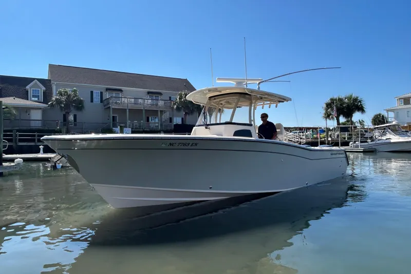 Slide: The Image of 2020 Grady-White Canyon 306 boat docked in a sunny marina setting. - 4