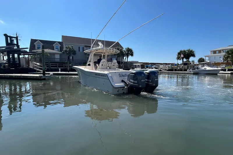 Slide: The Image of 2020 Grady-White Canyon 306 boat docked in a sunny marina setting. - 7