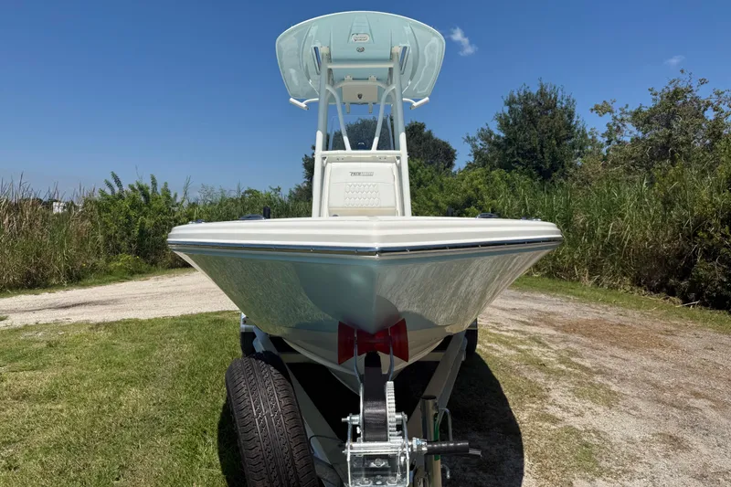 Slide: The Image of 2026 Pathfinder 2200 TRS boat on trailer, parked on grassy area under clear blue sky. - 10