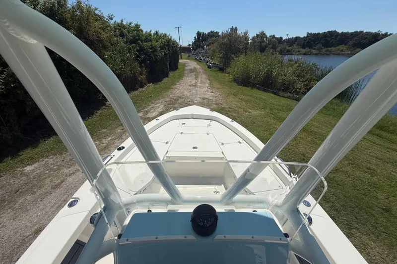 Slide: The Image of 2026 Pathfinder 2200 TRS boat on a grassy path by a lake. - 15