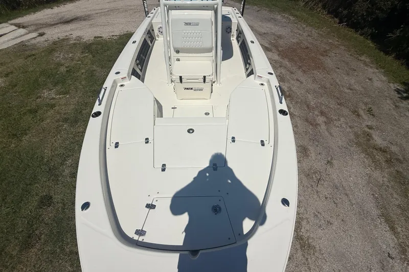 Slide: The Image of 2026 Pathfinder 2200 TRS boat on grassy terrain, showcasing spacious deck and seating. - 18