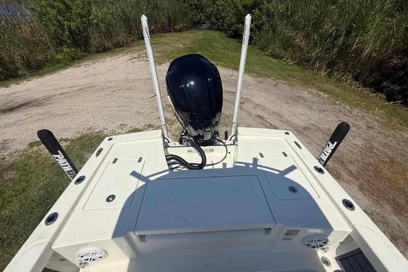 Slide: The Image of 2026 Pathfinder 2200 TRS boat stern view with motor and power poles. - 23