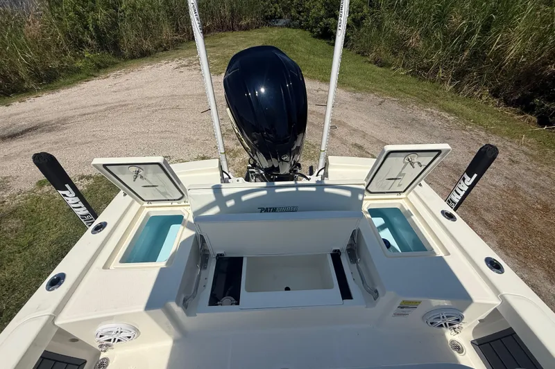 Slide: The Image of 2026 Pathfinder 2200 TRS boat with open storage compartments and motor, viewed from above. - 25