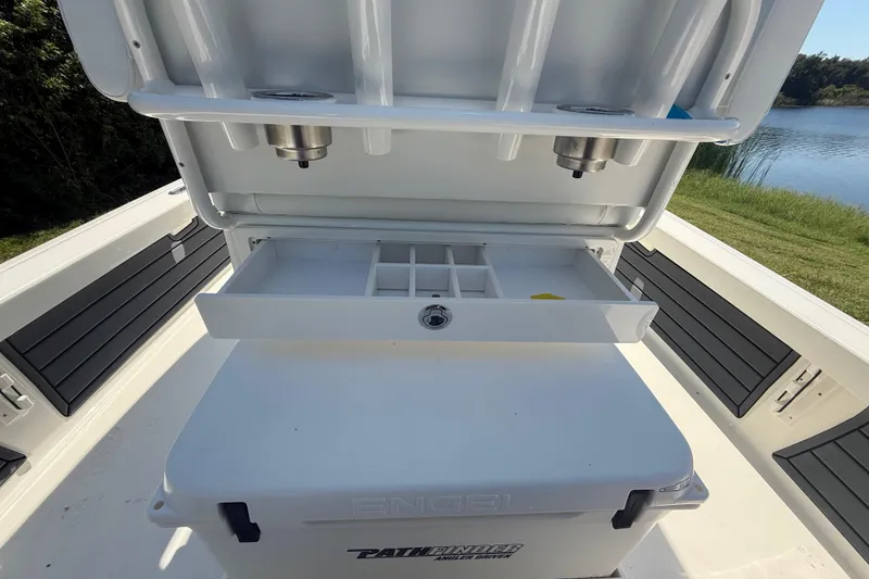 Slide: The Image of 2026 Pathfinder 2200 TRS boat with open storage compartment and tackle organizer. - 30