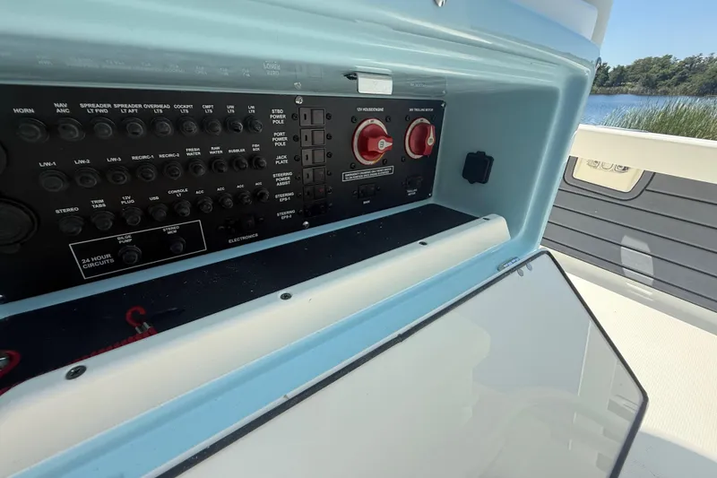 Slide: The Image of Control panel of 2026 Pathfinder 2200 TRS boat, featuring various switches and controls. - 32