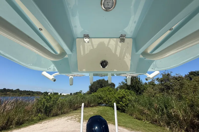 Slide: The Image of Underneath view of 2026 Pathfinder 2200 TRS boat, showcasing hull design and rod holders. - 35