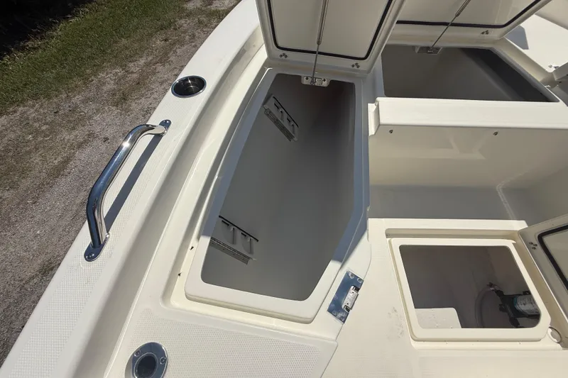 Slide: The Image of 2026 Pathfinder 2200 TRS boat storage compartments with open hatches and stainless steel handle. - 38