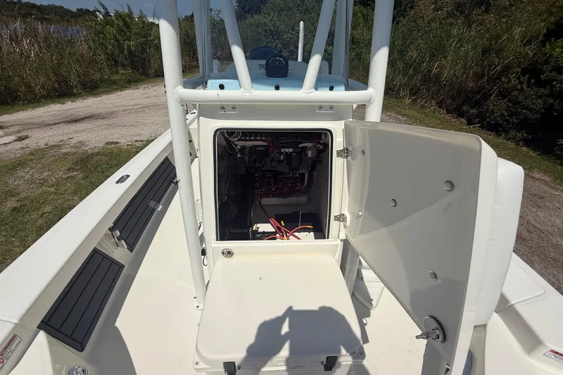 Slide: The Image of 2026 Pathfinder 2200 TRS boat with open console storage, showing internal wiring and components. - 44