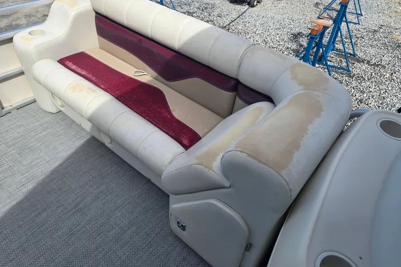 Slide: The Image of Side view of a 2003 Sweetwater 2019RE pontoon boat with maroon graphics. - 11