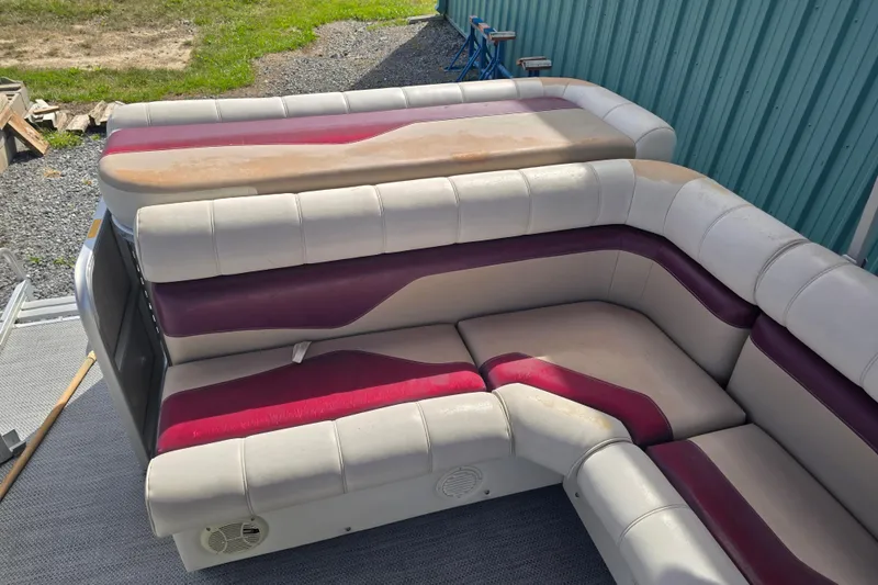 Slide: The Image of Sweetwater 2019RE pontoon boat with Honda motor, covered in red, parked outdoors. - 19