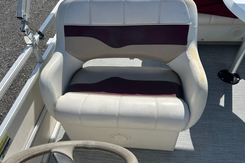 Slide: The Image of Outboard motor of a SWEET WATER 2019RE, 2003 model, displayed outdoors. - 24