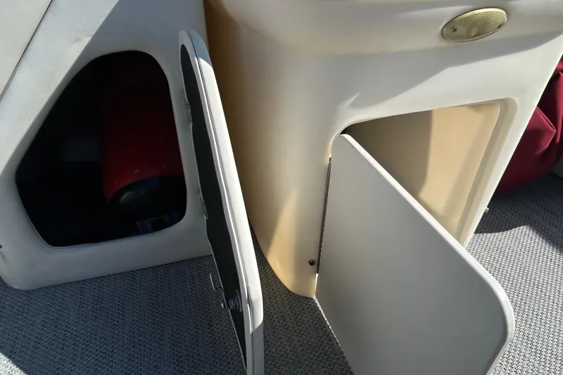 Slide: The Image of Interior of a 2003 Sweetwater 2019RE boat with cushioned seating and open deck space. - 26