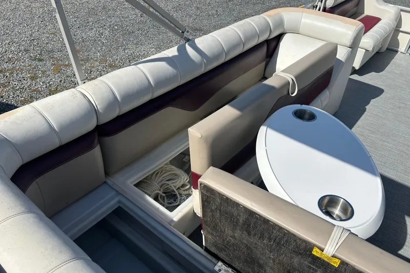 Slide: The Image of Open storage compartments on a 2003 Sweetwater 2019RE boat, revealing interior space. - 32