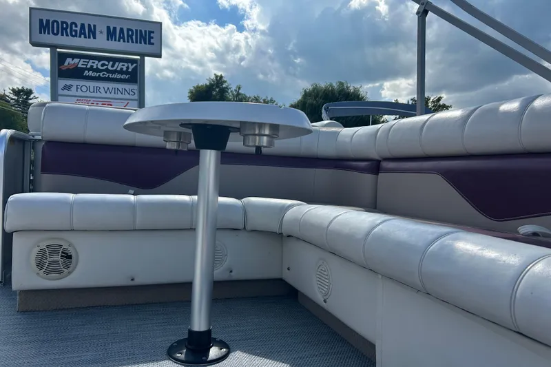 Slide: The Image of Steering console of a 2003 Sweetwater 2019RE boat with controls and seating. - 34