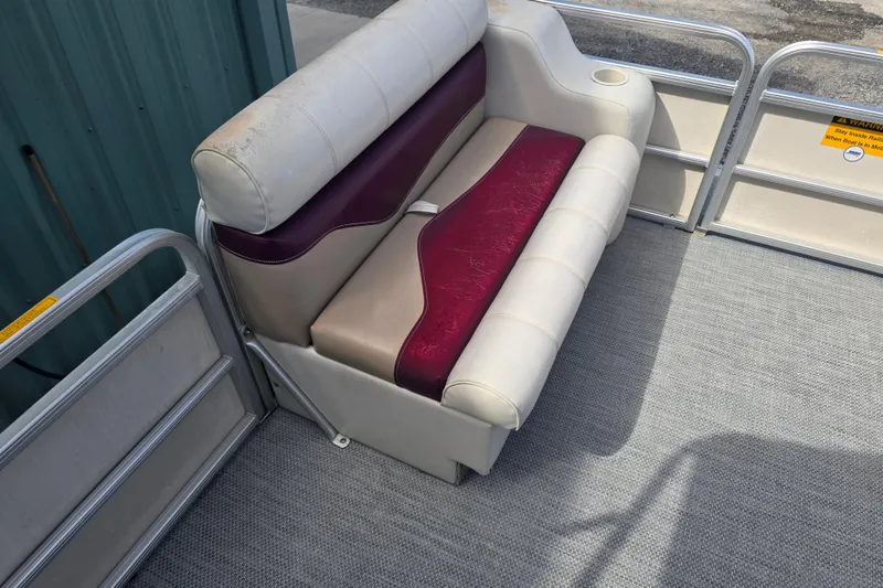 Slide: The Image of Interior of a 2003 Sweetwater 2019RE boat with seating and a table. - 38