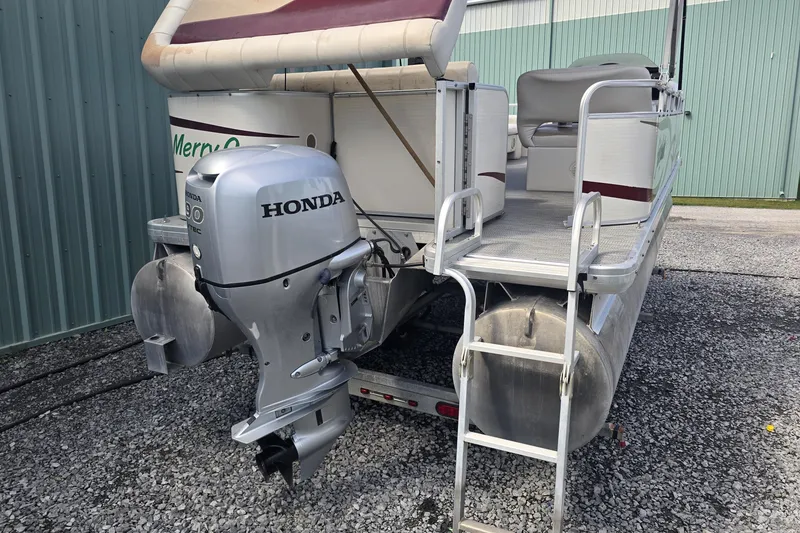 Slide: The Image of Sweetwater 2019RE pontoon boat, 2003 model, with maroon graphics and aluminum siding. - 4