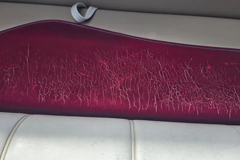 Slide: The Image of White and maroon boat seating on a SWEET WATER 2019RE, 2003 model. - 43