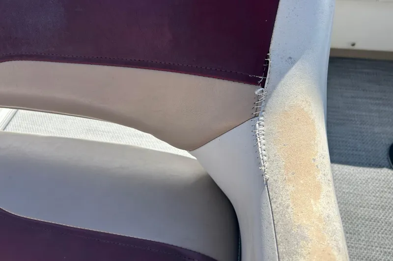 Slide: The Image of Sweetwater 2019RE boat interior, featuring white and purple seating, 2003 model. - 52