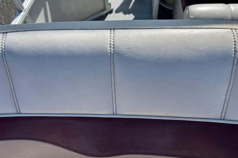 Slide: The Image of Aged Sweetwater 2019RE boat seat with faded upholstery, showing wear and discoloration. - 53