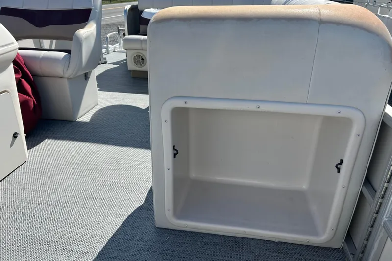 Slide: The Image of Interior of a 2003 Sweetwater 2019RE boat showing seating and table detail. - 56