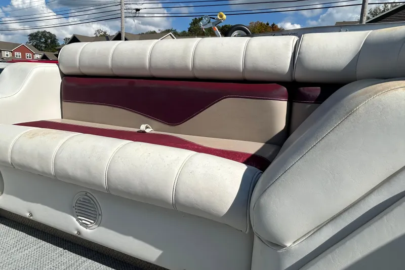 Slide: The Image of White and maroon boat seat upholstery on a 2003 Sweetwater 2019RE model. - 59