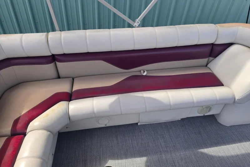 Slide: The Image of Red-covered Sweetwater 2019RE pontoon boat with Honda motor, parked outdoors. - 6
