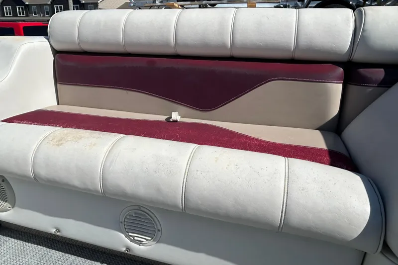 Slide: The Image of Interior of a 2003 Sweetwater 2019RE boat with white seating and speakers. - 60
