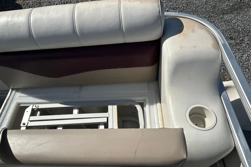 Slide: The Image of Interior of a 2003 Sweetwater 2019RE boat, featuring storage compartment and textured flooring. - 63