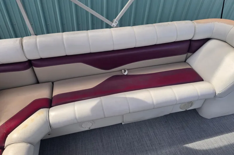 Slide: The Image of Sweetwater 2019RE pontoon boat with Honda outboard motor, parked on gravel. - 7