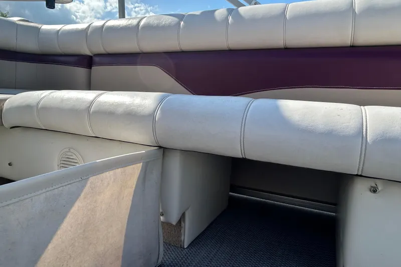 Slide: The Image of Boat seating with maroon and beige upholstery, featuring a cup holder, Sweetwater 2019RE model. - 70