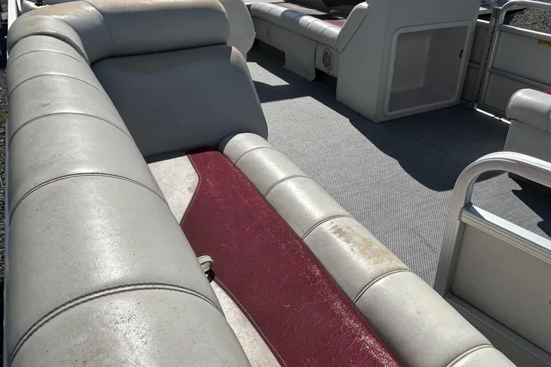 Slide: The Image of Interior of a 2003 Sweetwater 2019RE boat with gray and red seating. - 73