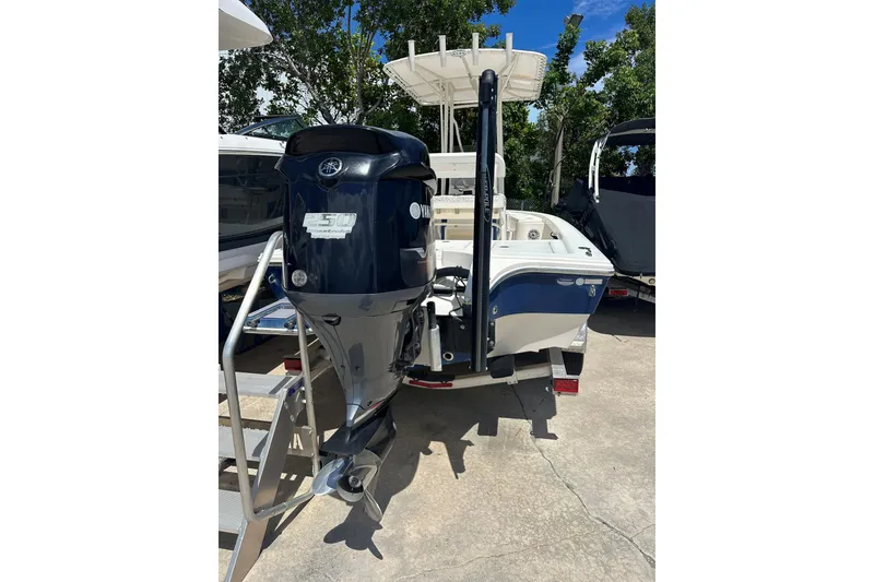Slide: The Image of 2014 Pathfinder 2300 HPS boat with Yamaha outboard motor, parked outdoors. - 1
