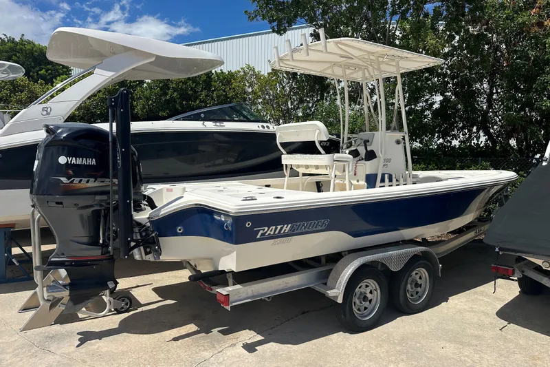 Slide: The Image of 2014 Pathfinder 2300 HPS boat with Yamaha engine on trailer, parked outdoors. - 10