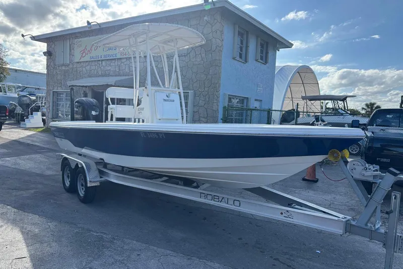 Slide: The Image of 2014 Pathfinder 2300 HPS boat on trailer outside a sales and service building. - 9