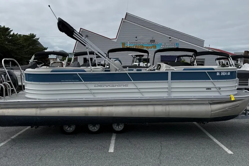 The Image of 2025 Berkshire 24RFX LE 2.75 pontoon boat in parking lot, side view. - 1
