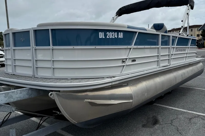 Slide: The Image of 2025 Berkshire 24RFX LE 2.75 pontoon boat on trailer in parking lot. - 4