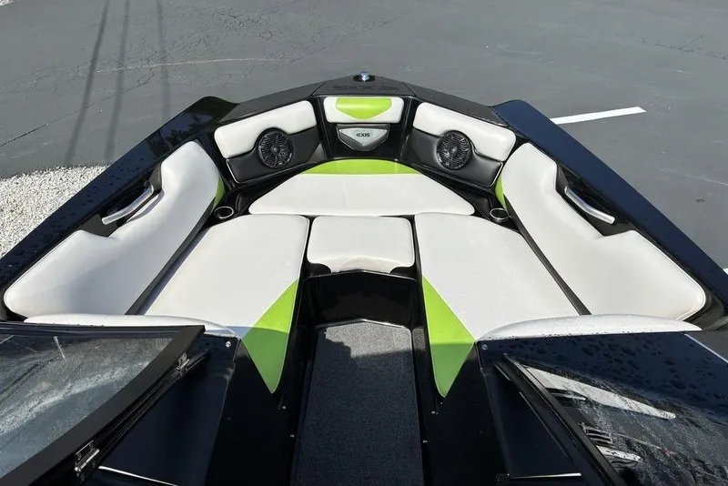 Slide: The Image of 2014 Axis A24 boat interior with white and green seating, featuring built-in speakers. - 3
