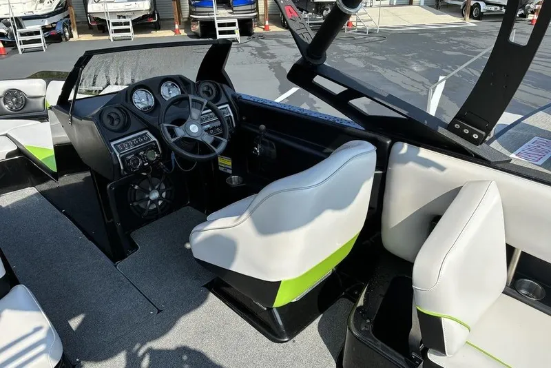 Slide: The Image of 2014 Axis A24 boat interior with steering wheel, dashboard, and seating. - 8