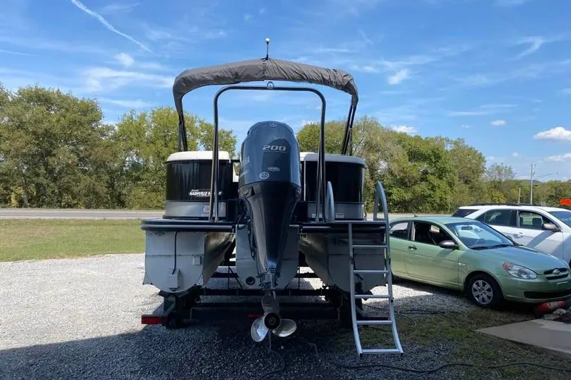 Slide: The Image of 2023 G3 Suncatcher Select Series 322RC pontoon boat with outboard motor, parked outdoors. - 4