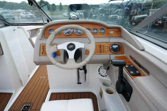 Slide: The Image of Interior of a 2000 Cobalt 226 boat featuring a detailed dashboard and steering wheel. - 10