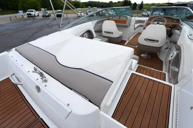 Slide: The Image of 2000 Cobalt 226 boat interior with white seating and wooden flooring. - 13