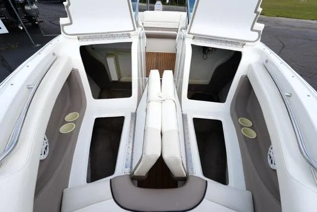 Slide: The Image of 2000 Cobalt 226 boat interior with open storage compartments and white seating. - 6