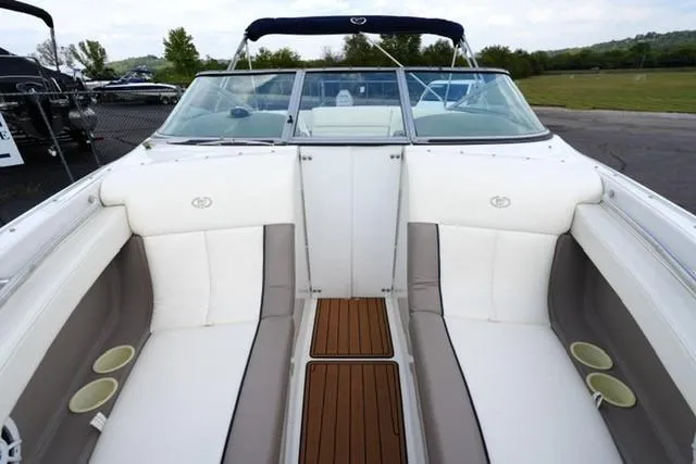 Slide: The Image of 2000 Cobalt 226 boat interior with white seating and wooden flooring. - 7
