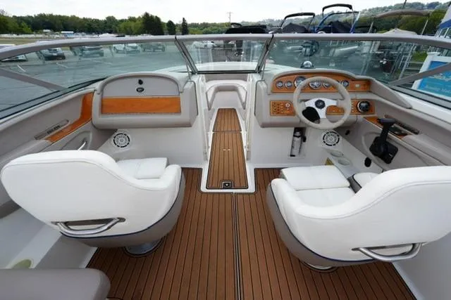 Slide: The Image of Interior of a 2000 Cobalt 226 boat with white seats and wooden dashboard. - 8