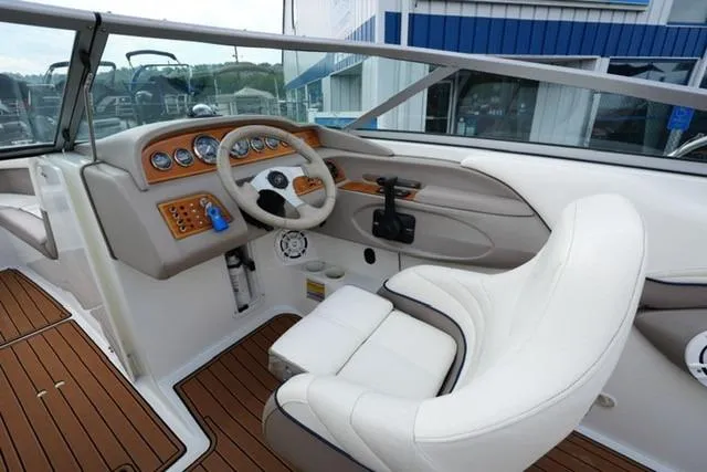 Slide: The Image of Interior of a 2000 Cobalt 226 boat with white seating and wooden dashboard. - 9